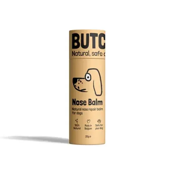  Envase cilíndrico amarillo de Nose Balm para perros, un bálsamo natural diseñado para hidratar y proteger la nariz seca o agrietada. El diseño muestra iconos indicando que es 100% natural, hecho en Bélgica y seguro para los perros.